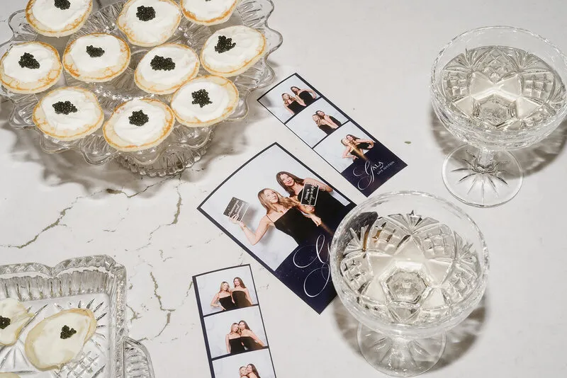 Printed photo strips laid out beside desserts and glasses