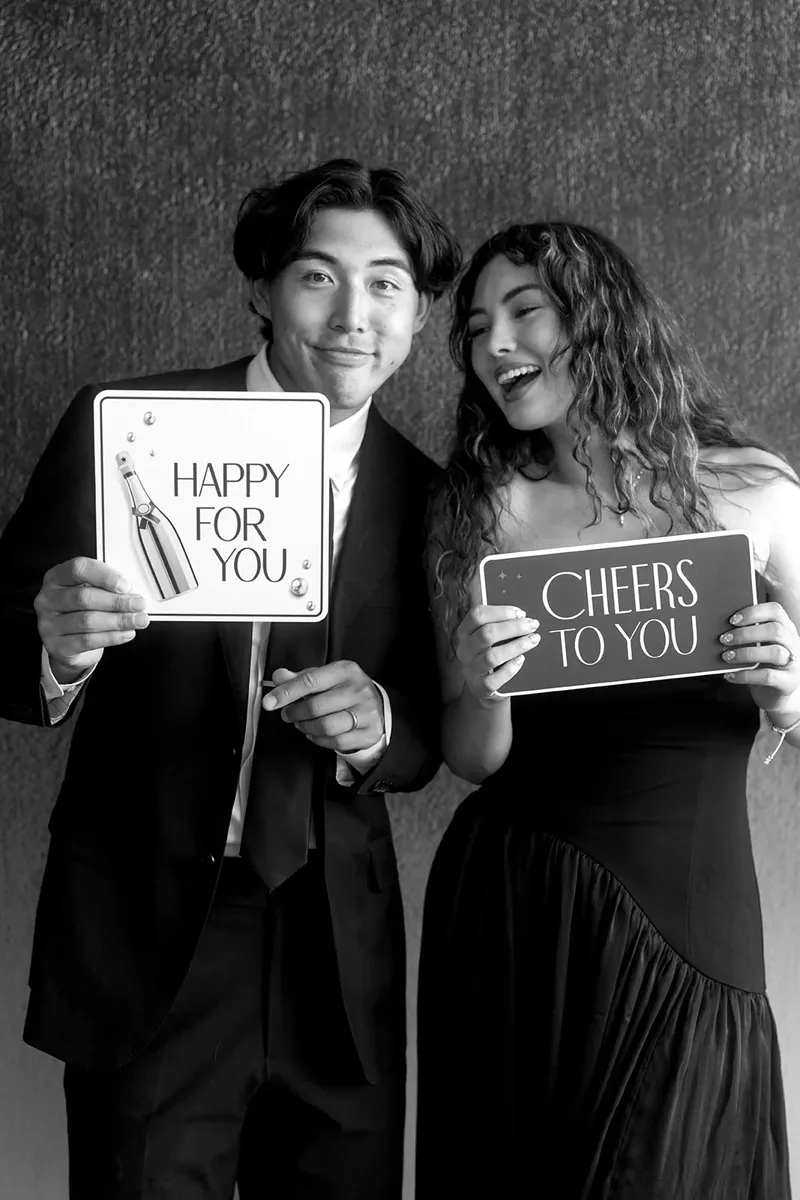Guests holding photo booth prop signs