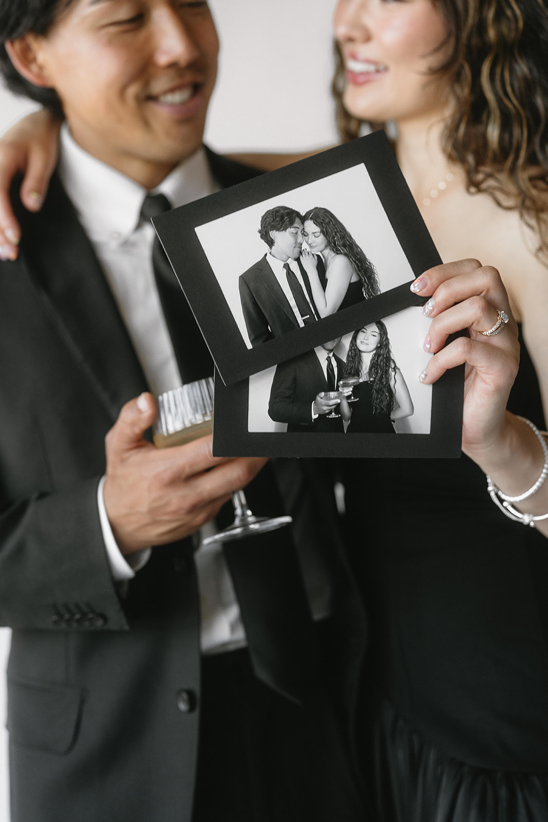 A guest holding a framed photo strip